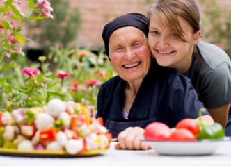 caregiver and senior woman smiling