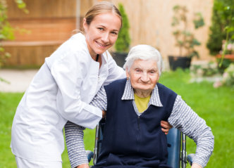 caregiver and senior woman smiling