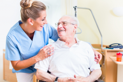 senior men and female nurse smiling